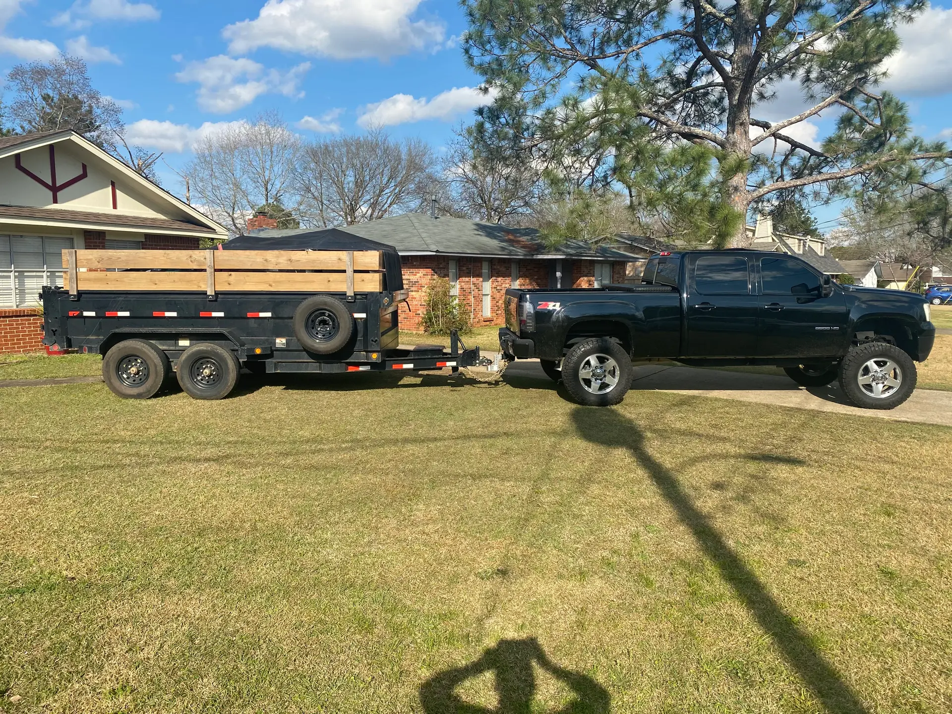 Melanin Site Solutions truck and dump trailer parked at a residential job in Montgomery