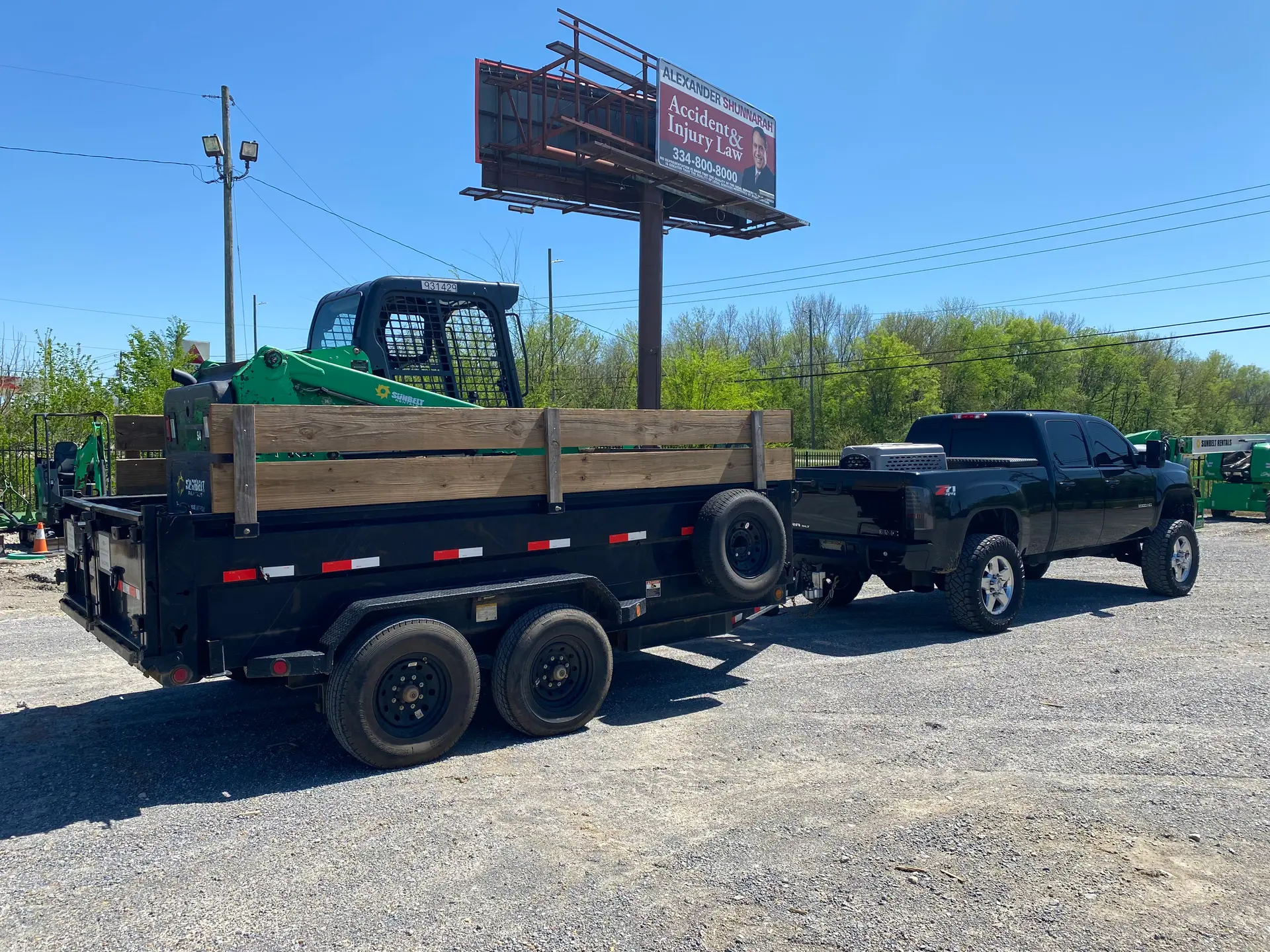 Mini skid steer hauled on a trailer to a Montgomery job site