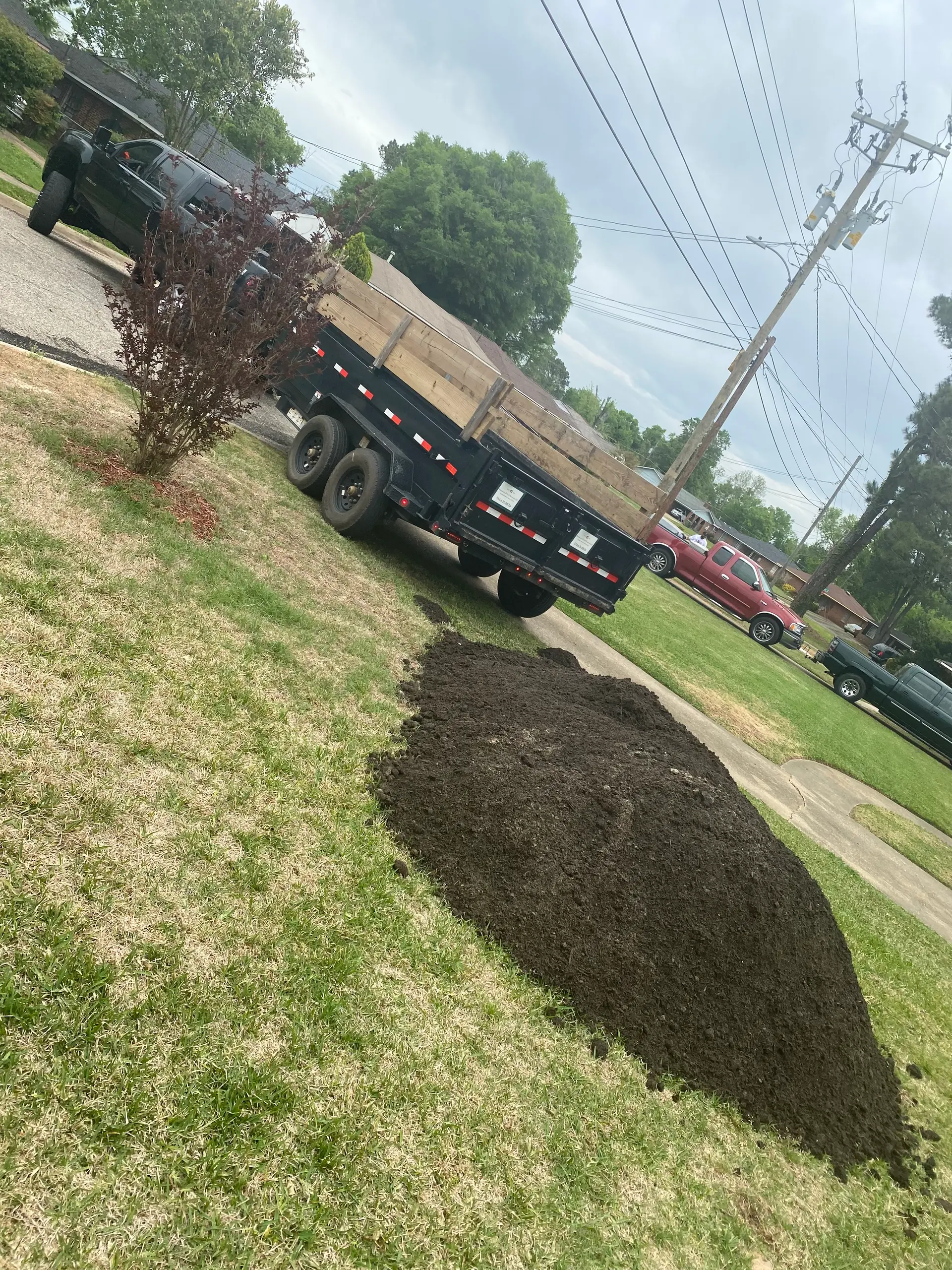 Mulch delivered and dumped on a residential lawn for spreading