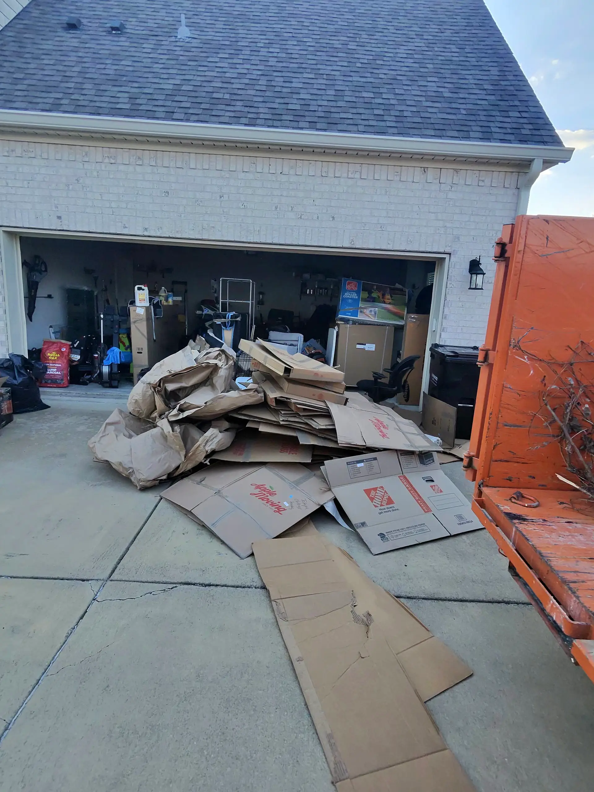 Garage cleanout with cardboard piled next to a SiteTub Tub